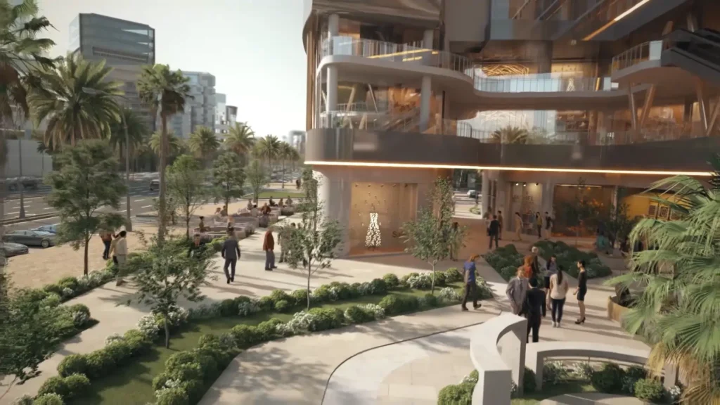 Modern commercial building with landscaped outdoor area and people walking.