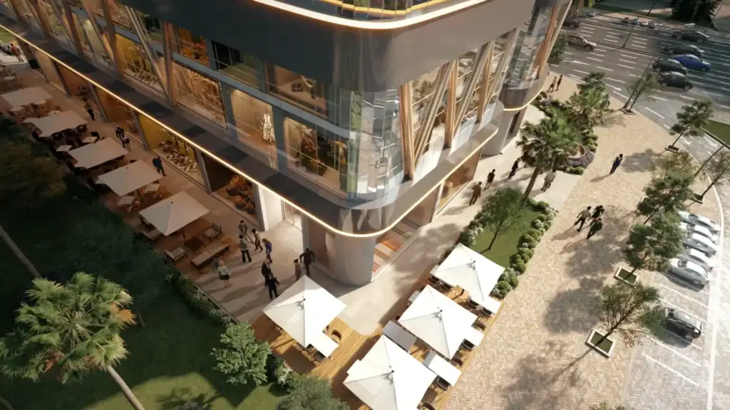 Modern commercial building with outdoor seating and parking area.