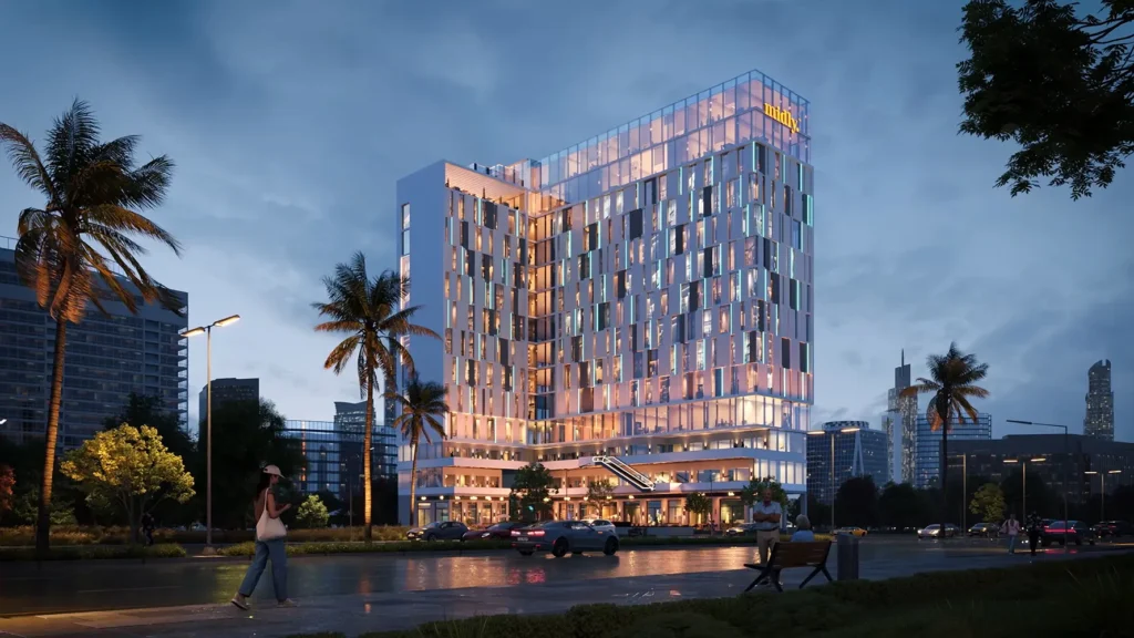 Modern iCapital building with glass facade and palm trees at sunset.