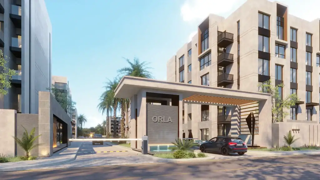 Contemporary apartment complex entrance with palm trees and parking area.