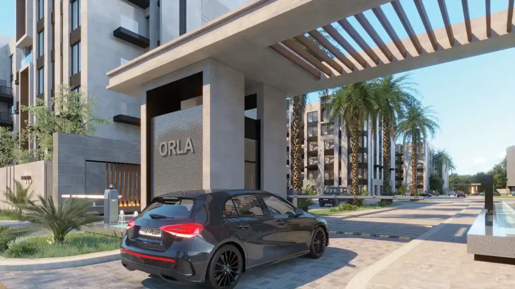 Modern residential entrance with a parked car and palm trees.