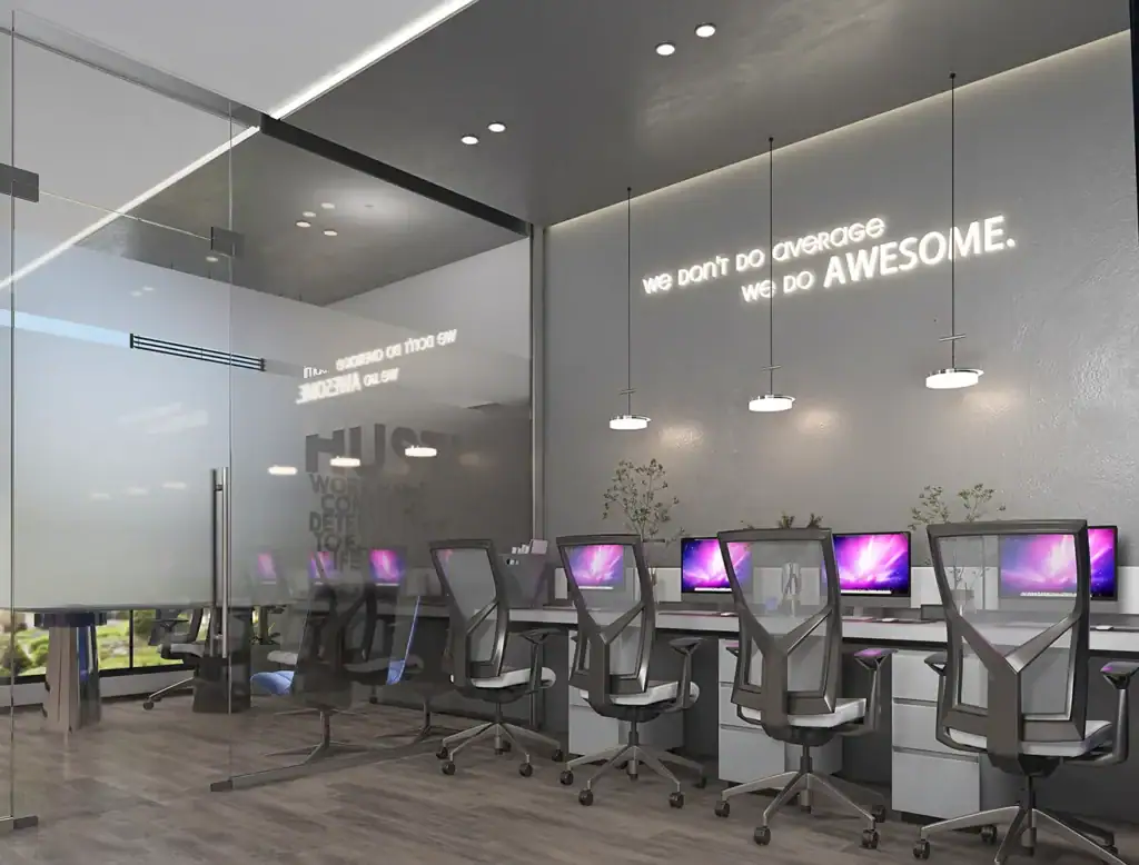Contemporary office space with computers and motivational wall quotes.