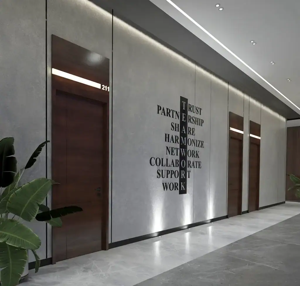 Modern office hallway with motivational wall art at i8 Business Complex.