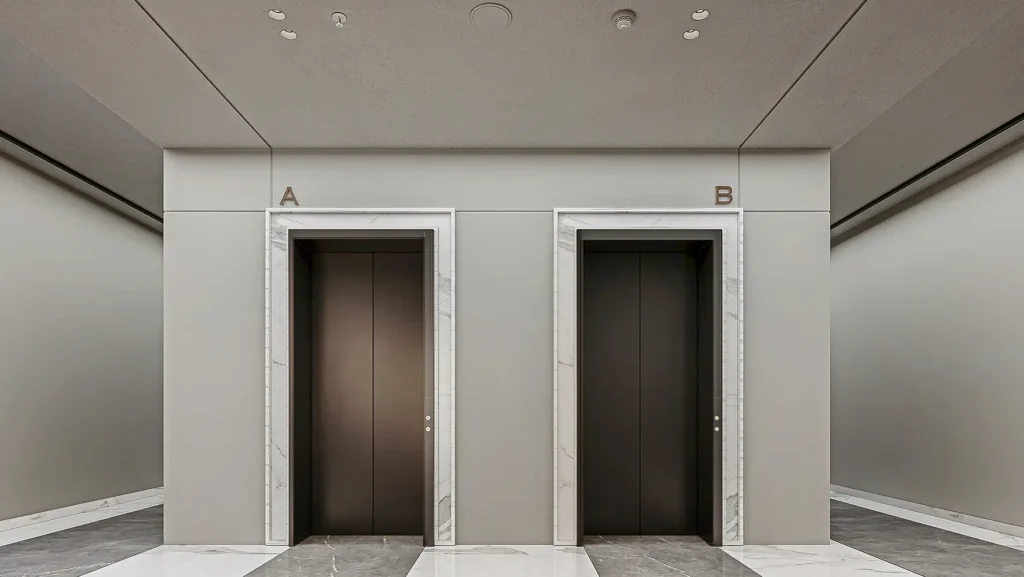Two sleek elevator doors in a modern building at Orla Residence.